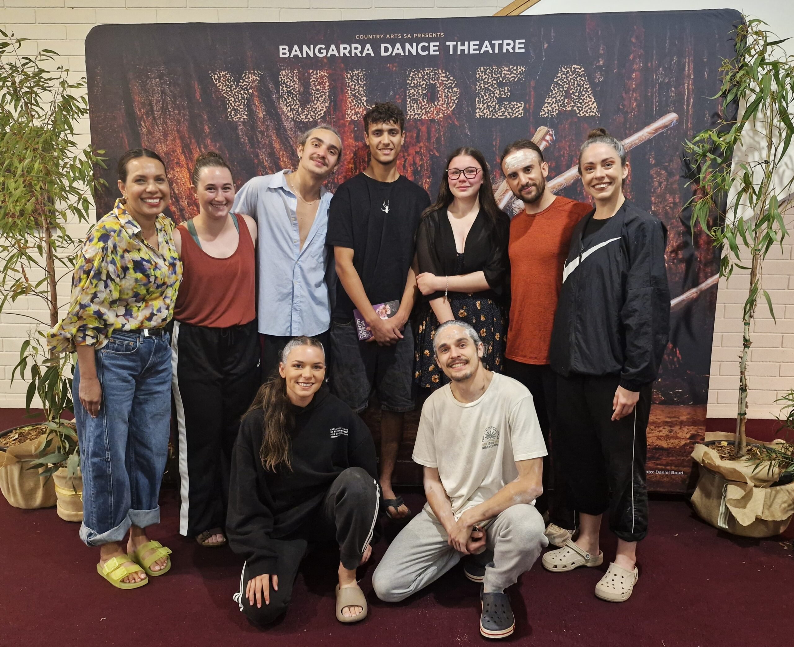 Students posing for a photo with performers from Bangarra Dance Theatre after their performance of Yuldea, in Whyalla.